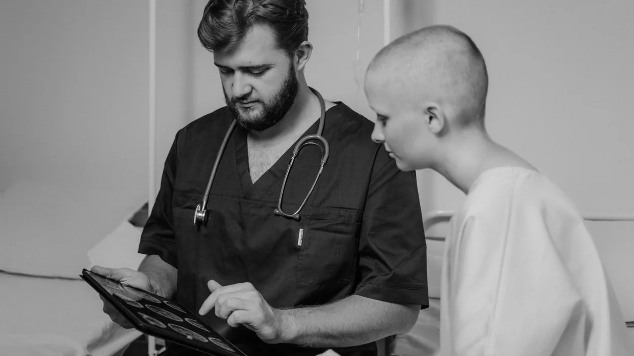 A clinician and patient reviewing care on a tablet.